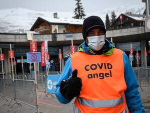 A ski lift staff identified as "Covid Angel" to remind skiers Covid-19 guidance poses on December 21, 2020 in the Swiss alpine ski resort of Verbier as Switzerland imposed an entry ban on arrivals from Britain and South Africa to stop tourism from countries following the discovery there of new, more contagious variants of Covid-19.  Fabrice COFFRINI / AFP