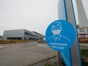 A picture shows a sign reading "Mandatory face mask" at the US pharmaceutical giant Pfizer plant in Puurs, northeast Belgium, on December 23, 2020, on the day trucks carrying the first batches of the Pfizer-BioNTech Covid-19 (novel coronavirus) vaccines for EU citizens left the plant, ahead of a rollout across the 27-nation bloc. Member states are set to start issuing the Pfizer-BioNTech inoculations from December 27 after the European Medicines Agency (EMA) Union's medicines regulator gave the green light 