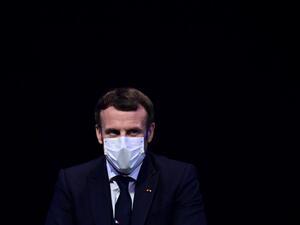 In this file photo taken on December 14, 2020 French President Emmanuel Macron attends a ceremony marking the 60th anniversary of the creation of the Organisation for Economic Co-operation and Development (OECD), at its headquarters in Paris. French President Emmanuel Macron, who had tested positive for Covid-19 on December 17, "is no longer presenting any symptoms" and his isolation of seven days can therefore stop, the Elysee Palace said in a statement on December 24, 2020. MARTIN BUREAU / POOL / AFP