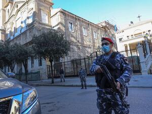 Lebanese security members stand guard in front of Saint George Church in Downtown Beirut, on December 25, 2020, still closed down for renovations after the deadly August 4 port blast in the capital. ANWAR AMRO / AFP