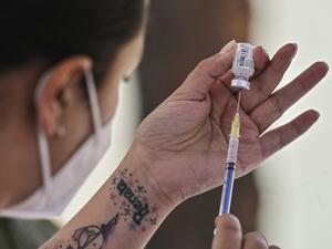 A health worker prepares the Pfizer/BioNTech COVID-19 vaccine jab, at the Military College in Mexico City, on December 27, 2020. Dozens of nurses and doctors felt they had regained "peace of mind" and strength to continue fighting the COVID-19 pandemic, after being vaccinated against the disease this Sunday in Mexico. PEDRO PARDO / AFP