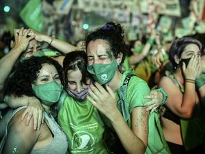 Pro-choice activists celebrate after the Senate approved a bill to legalize abortion outside the Congress in Buenos Aires on December 30, 2020. RONALDO SCHEMIDT / AFP