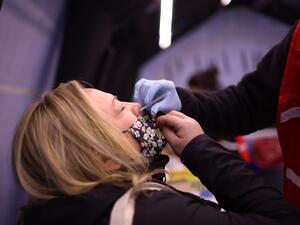 Kristin Nowak gets tested for Covid-19 at a mobile test site being run by Roseland Community Hospital on December 12, 2020 in Chicago, Illinois. The seven-day positivity rate in Illinois has been slowly receding but currently stands a 10.8%. Scott Olson/Getty Images/AFP