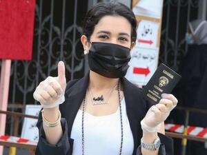 A Kuwaiti woman voter arrives to cast her ballot at a polling station in Kuwait City during parliamentary elections on December 5, 2020. (AFP)
