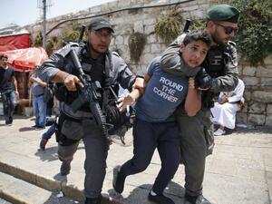 Israeli border guards detain a Palestinian boy during a demonstration outside the Lions Gate, a main entrance to Al-Aqsa mosque compound on 17 July 2017 (AFP)