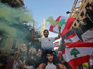 Lebanese protesters demand better living conditions and the removal of a cast of politicians who have monopolised power and influence for decades at Riad al-Solh Square in Beirut (AFP)