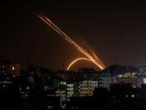 Illustrative: Rockets are fired from the Gaza Strip toward Israel, on November 13, 2019. (Anas Baba/AFP)