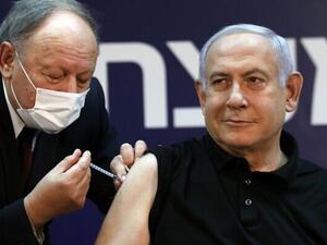Prime Minister Benjamin Netanyahu receives a coronavirus vaccine, from his personal physician Dr. Tzvi Berkovitz, at Sheba Medical Center in Ramat Gan, on December 19, 2020, becoming the first Israeli to get the vaccine. (Amir Cohen/Pool/AFP)