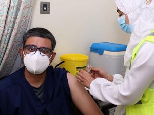 A doctor receives his first dose of the Pfizer-BioNTech COVID-19 vaccine in the Omani capital Muscat on December 27, 2020. MOHAMMED MAHJOUB / AFP