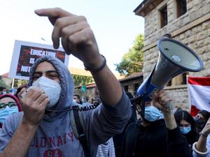 Demonstrators chant slogans during a demonstration outside the entrance of the American University of Beirut, in the Lebanese capital's Bliss street on December 29, 2020, against the decision by a number of universities to adopt a new dollar exchange rate to price tuition. ANWAR AMRO / AFP
