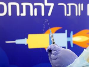 A healthcare worker prepares a dose of the Pfizer-BioNtech Covid-19 vaccine at a large vaccination centre open by the Tel Aviv-Yafo Municipality and Tel Aviv Sourasky Medical Center on December 31, 2020 in the Israeli coastal city. Israel began its third coronavirus lockdown, as Prime Minister Benjamin Netanyahu voiced optimism that a "world record" vaccination drive will restore a degree of normality within weeks. JACK GUEZ / AFP