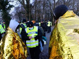 French Gendarmes writes down the details of youth following the break up of a party near a disused hangar in Lieuron about 40km (around 24 miles) south of Rennes, on January 2, 2021. Some 2,500 partygoers attended an illegal New Year rave in northwestern France, violently clashing with police who failed to stop it and sparking concern the underground event could spread the coronavirus, authorities said Friday. JEAN-FRANCOIS MONIER / AFP