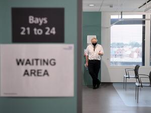 Britain's Prime Minister Boris Johnson speaks to NHS staff (unseen) waiting to receive a dose of the AstraZeneca/Oxford Covid-19 vaccine during a visit to Chase Farm Hospital in north London on January 4, 2021, the day that Britain's NHS (National Health Service) ramps up its vaccination programme with the rollout of the newly approved AstraZeneca/Oxford COVID-19 vaccine jab. AFP/File