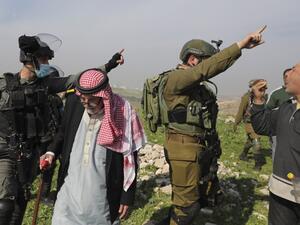 Palestinian farmers protest after Israeli security forces uprooted olive trees reportedly located within the area C (where Israel retains control, including over planning and construction) in the West Bank village of Deir Ballut on January 6, 2021. JAAFAR ASHTIYEH / AFP