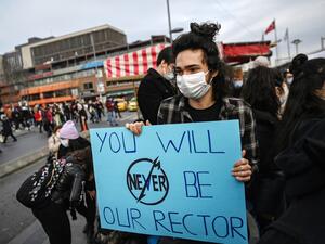 A student holds a placard as they march to Besiktis district from Bogazici university on January 6, 2021 in Istanbul during a protest against the direct appointment of the new rector to Bogazici university by Turkish President. Turkish police detained 17 people after hundreds attended a student-led protest against the appointment by the President of a rector of a top university in Istanbul.  Ozan KOSE / AFP