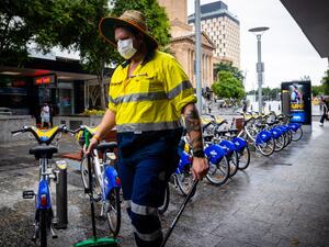 A Brisbane City Council worker wears a mask along the Queen Street Mall in Brisbane on January 8, 2021, as Australia's third-largest city headed into lockdown and borders set to tighten nationwide after a cleaner at a quarantine hotel contracted the UK coronavirus strain that appears to be more infectious. Patrick HAMILTON / AFP