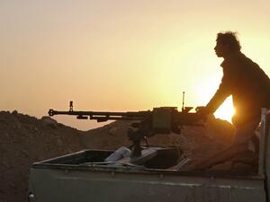 In this file photo a combatant mans a heavy machine gun as forces loyal to Yemen's Saudi-backed government clash with Huthi rebel fighters around the strategic government-held "Mas Camp" military base, in al-Jadaan area about 50 kilometres northwest of Marib in central Yemen, on November 22, 2020. AFP