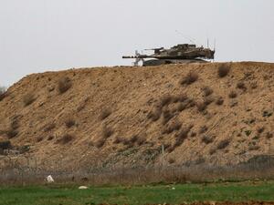 An Israeli tank is pictured on Israel's border with Gaza, opposite the Palestinilan city of Khan Yunis in the southern Gaza Strip, on January 13, 2021. The Israeli army fired artillery at Hamas targets in Gaza in response to what it described as gunfire from within Gaza on an "engineering vehicle" operating near the border.  SAID KHATIB / AFP