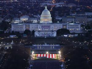The US Capitol Building is prepared for the inauguration ceremonies for President-elect Joe Biden as the "Field of Flags" are placed on the ground on the National Mall on January 18, 2021 in Washington, DC. Approximately 191,500 US flags will cover part of the National Mall and will represent the American people who are unable to travel to Washington, DC for the inauguration. Joe Raedle / POOL / AFP