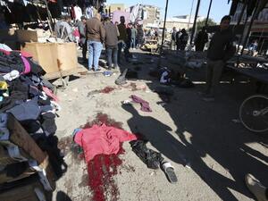 A picture shows the scene of a twin suicide bombing on a bustling commercial street in the heart of Baghdad on January 21, 2021. The toll in a twin suicide bombing in an open-air Baghdad market morning topped 20 dead and 40 wounded, an interior ministry official told AFP. The ministry said the first suicide bomber had rushed into the market and claimed to feel sick, so that people would gather around him. He then detonated his explosives. Sabah ARAR / AFP