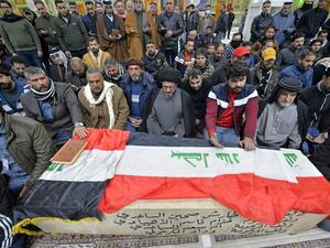 Iraqi mourners pray over the coffin of a victim who was killed in a twin suicide bombing in central Baghdad, during a funeral in the holy city of Najaf on January 21, 2021. A rare twin suicide bombing killed 32 people and wounded 110 at a crowded market in central Baghdad, Iraq's government said, the city's deadliest attack in three years. The first attacker drew a crowd at the bustling market in the capital's Tayaran Square by claiming to feel sick, then detonated his explosives belt, the interior ministry