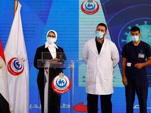 (L to R) Egyptian Health Minister Hala Zayed gives a press conference, accompanied by doctor Abdelmouim Selem and medical staff member Ahmed Hemdan, in a tent set up outside the Abou Khalifa hospital, in Ismailia, about 120kms east the capital Cairo, on January 24, 2021, after the two men received a dose of a coronavirus vaccine. Egypt began its nationwide Covid-19 immunisation program today, with a doctor and a nurse receiving the Chinese-made Sinopharm jab. Khaled DESOUKI / AFP