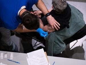 A patient receives a Covid-19 vaccine at the Virginia Mason vaccine clinic hosted at the Amazon Meeting Center in downtown Seattle, Washington on January 24, 2021. Amazon is partnering with Virginia Mason for a one-day pop-up clinic on January 24. 2021 that aims to vaccinate 2,000 people at the company’s Meeting Center near downtown Seattle. Virginia Mason is handling vaccine administration, while Amazon is providing the location and help with logistics. Grant HINDSLEY / AFP