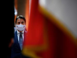 In this file photo taken on July 14, 2020, Italian Prime Minister Giuseppe Conte wearing a face mask attends a handover ceremony of the piece of art attributed to street artist Banksy, that was stolen at the Bataclan in Paris in 2019, and found in Italy, at the French embassy in Rome. Italian Prime Minister Giuseppe Conte will resign January 26, 2021, his office said on January 25, 2021, in what media reports said was a move to secure a mandate for a new government after weeks of turmoil. A statement from C