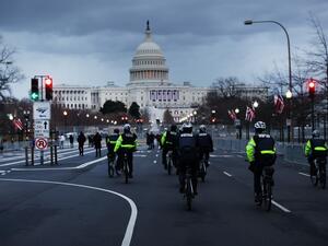 Police officers patrol a street leading to the U.S. Capitol on January 16, 2021 in Washington, DC. The National Guard is expected to deploy more than 20,000 troops in and around the Capitol and many area businesses will remain closed for the period leading up to the January 20th inauguration of Joseph Biden as president. SPENCER PLATT / GETTY IMAGES NORTH AMERICA / Getty Images via AFP
