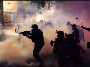 Federal officers deploy tear gas and less-lethal munitions while dispersing a crowd of about a thousand protesters in front of the Mark O. Hatfield US Courthouse in Portland, Oregon. Picture: AFP