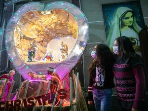 Egyptian Christians worshippers attend Christmas Eve mass at the Coptic Catholic St. Mark Church in Minya city, some 245 kilometres south of the capital Cairo on January 6, 2021. (AFP)