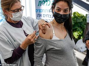 Pictured: A health worker administers a dose of the Pfizer-BioNTech COVID-19 at Clalit Health Services, in Tel Aviv, January 23. (AFP)