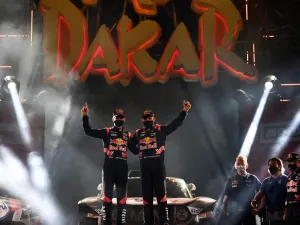 Mini's driver Stephane Peterhansel and his co-driver Edouard Boulanger of France celebrate their victory on the podium after winning the Dakar Rally 2021. (Photo: FRANCK FIFE / AFP)