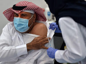 The first Saudi citizen to receive the Pfizer-BioNTech COVID-19 vaccine prepares for the shot in Riyadh, Saudi Arabia. (Fayez Nureldine/AFP)