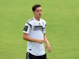 The midfielder confirmed he won't be going back on his decision to retire from international football after being unveiled at Fenerbahce (Photo: AFP)