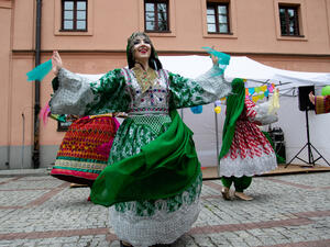 Women dance Afghan folk dance in folk Afghan costumes on the Krakowskie przedmiescie street. (Shutterstock/ File Photo)