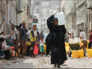 A Yemeni woman carries a plastic container filled with water in the southern Red Sea port city of Aden on July 19. (Saleh Al-Obeidi/AFP via Getty Images)