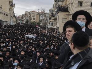 Thousands of Ultra-Orthodox Jews attend a funeral procession for the Head of the Brisk Yeshiva, Rabbi Meshulam Dovid Soloveitchik in Jerusalem on January 31, 2021, following his passing aged 99 due to months-long illness compounded by the coronavirus. MENAHEM KAHANA / AFP