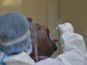 A health worker collects a swab sample from a man to test for the Covid-19 coronavirus at the KC General Hospital in Bangalore on February 1, 2021. Manjunath KIRAN / AFP