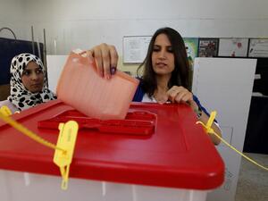 In this file photo taken on July 7, 2012, a woman casts her ballot at a polling station in the eastern city of Benghazi during Libya's General National Congress election. Ten years after Libya's NATO-backed uprising ousted and killed dictator Moamer Kadhafi, the country remains wracked by conflict and chaos, its population bled dry despite the nation's vast oil wealth. A UN-led process has lifted cautious hopes that the latest fragile ceasefire will bring a lasting peace, but, for now, Libya is split in two