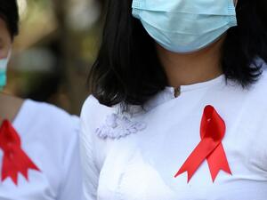 Department of Agriculture staff wear red ribbons on their uniforms in Naypyidaw on February 4, 2021 after calls for protest went out on social media, as Myanmar's ousted leader Aung San Suu Kyi was formally charged on February 3 two days after she was detained in a military coup. STR / AFP