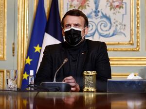 French President Emmanuel Macron, wearing a protective face mask, attends a video-conference meeting with World Health Organization (WHO) Director-General Tedros Adhanom Ghebreyesus (unseen) at the Elysee Palace in Paris amid the coronavirus disease (COVID-19) pandemic on February 8, 2021. CHRISTIAN HARTMANN / POOL / AFP