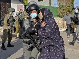 A woman reacts as Israeli security forces demolish the house of Palestinian Mohammed Cabha who has confessed to the murder of French-Israeli settler Esther Horgen, in the West Bank village of Tura al-Gharbiya near Jenin, on February 10, 2021. JAAFAR ASHTIYEH / AFP
