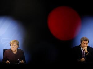 German Chancellor Angela Merkel (L) and Bavarian State Premier Markus Soeder (R) hold a news conference following talks via video conference with Germany's state premiers on the extension of the current lockdown due to the coronavirus COVID-19 pandemic, at the Chancellery in Berlin, on February 10, 2021. Markus SCHREIBER / POOL / AFP
