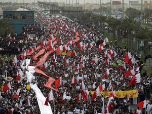 In this file photo taken on February 25, 2011 Bahraini Shiite anti-government protesters chant slogans against the regime during a rally in remembrance of the seven people who were killed in police crackdowns as they march towards Pearl Square in Manama. With a popular, reform-minded crown prince newly installed as prime minister, and a decade passed since the Arab Spring, Bahrain should be well placed to cast off the painful legacy of its uprising. The Pearl monument in downtown Manama -- the centre of the
