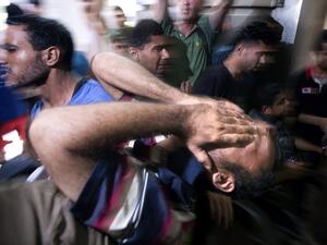 In this file photo taken on July 16, 2014, a Palestinian relative of the four boys killed in Israeli bombardment while playing on the beach, all from the extended Bakr family, reacts at the morgue of the al-Shifa hospital in Gaza City. The International Criminal Court's ruling that it has jurisdiction over the situation in the Palestinian territories opens the way to it investigating alleged war crimes committed in the 2014 Israeli-Palestinian conflict in Gaza. In the summer of 2014, Israel launched what it