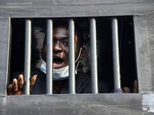Twenty four-year-old protester Damilare Adenola speaks from a black truck as he is detained after being arrested along with 13 other protesters during a demonstration against police brutality, at the Lekki tollgate in Lagos on February 13, 2021. Nigerian police arrested a small group of protesters in Lagos after they tried to hold a rally demanding justice for victims of a deadly shooting during demonstrations last year. Activists had called for new protests after a judicial panel authorised the reopening o