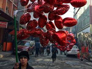 A child carries balloons to sell on Valentine's Day in Kabul on February 14, 2021. WAKIL KOHSAR / AFP