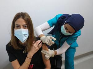A medic administers a dose of the COVID-19 Pfizer/BioNTech vaccine at Lebanon's American University Medical Center in the capital Beirut, on February 14, 2021, as the country kickstarts its inoculation campaign. Lebanon gave its first COVID-19 vaccine dose to a doctor, as it started inoculation it hopes will keep the pandemic in check amid a deepening economic crisis. ANWAR AMRO / AFP