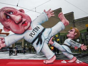 A carnival float depicting Russian opposition leader Alexei Navalny (R) dressed as a judoka kicking the balls of Russian President Vladimir Putin is seen during a slimmed down version of the traditional Rose Monday parade on February 15, 2021 in Duesseldorf, western Germany. Due to the novel coronavirus COVID-19 pandemic, traditional parades and festivities in Germany's carnival hotspots, mainly situated in the Rhineland region, had to be canceled or modified to conform to the rules and restrictions in orde